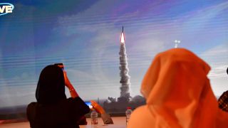 A picture taken on July 19, 2020, shows a screen broadcasting the launch of the "Hope" Mars probe at the Mohammed Bin Rashid Space Center in Dubai.