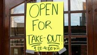A restaurant sign reads "Open For Take-Out" during the COVID-19 pandemic.