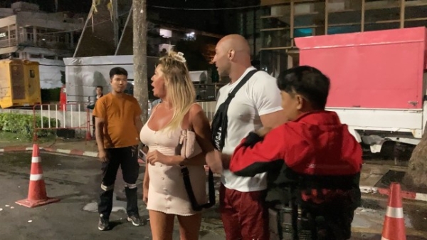 A drunk British woman is spending Christmas Day in a Thai prison cell after trying to have sex on a hotel's glass table before fighting with police. The blonde holidaymaker is said to have straddled her partner in the lobby before breaking the piece of furniture in Pattaya, Thailand, at 3am this morning. She allegedly ran away with the porter in pursuit before grappling with an armed officer in front of the beach. Bystanders eventually helped to subdue her. Footage shows the woman in a a white mini dress hurling vile insults at locals while being frogmached in handcuffs to the station. Her boyfriend had quietly slipped away.??????PACKAGE: Video, pictures, text