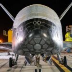 The US military has revealed that the top-secret X-37B space plane returned to Earth in the dead of night after a mysterious 434-day mission.