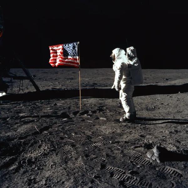 Buzz Aldrin and the U.S. Flag on the Moon, 1969. Astronaut Buzz Aldrin, lunar module pilot of the first lunar landing mission, poses for a photograph next to an unfurled U.S. flag during an Apollo 11 spacewalk on the lunar surface. The Lunar Module (LM) is to the left, and the astronauts' footprints are clearly visible in the lunar soil. Astronaut Neil A. Armstrong, the spacecraft commander, took this image using a 70 mm Hasselblad lunar surface camera. While astronauts Armstrong and Aldrin descended in the Eagle LM to explore the Sea of Tranquility region of the Moon, astronaut Michael Collins, command module pilot, remained with the Command and Service Module (CSM) Columbia in lunar orbit. Artist: Neil Armstrong. (Photo: Heritage Space/Heritage Images via Getty Images)