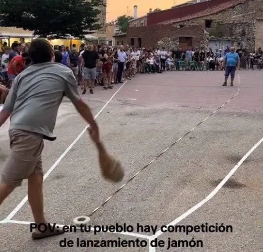 Story by Jam Press (Ham Throwing Competition) Pictured: Footage of villagers in a Spanish village holding an unusual annual competition to see who can throw a ham the furthest. VIDEO: Meat that suits you! Spanish village holds unusual ham throwing competition A Spanish village holds an unusual annual competition to see who can throw a ham the furthest. Footage from this year’s event shows contenders hurling hefty hams into a designated area, reminiscent of the landing area of a hammer throw. The unusual competition takes place every August in Carrascosa de la Sierra. Situated in the Spanish province of Soria, the village is home to just 70 permanent residents – but the population swells to 400 during the festive season. Known as the Campeonato de Lanzamiento de Pernil — the Ham Throwing Championship — the tradition began decades ago as a joke between friends at a local bar. It went viral this year thanks to 24-year-old Taglia Benedicto, who hails from the village and shared a montage of the event on social media. The thrown ham doesn’t go to waste — it’s wrapped in tape and bubble wrap before being launched, and serves as a trophy for whoever throws it the furthest. Tradition dictates, however, that the winner shares it with locals and visitors. This year’s men’s champion was Sergio Garcia, whose throw reached 20.55 meters, according to What’s The Jam. There are also categories for women, who throw the ham from the shoulder; children, who throw the salchichon; and even toddlers, who throw the mini-fuet. What began in 1997 as a quirky idea to liven up the August festivities has become a defining symbol of the village. “The locals are very happy because we have put Carrascosa on the map,” Talla told local media. Carrascosa is not the only town on Spain’s unusual festival scene. Carcabuey, in Cordoba province, hosts an olive pit-spitting championship. Galicia has a special turnip-top-throwing competition. Navarre hosts an espadrille-throwing competition. And in Castilla y León, competitors throw hoes in a bid for glory. EDITOR’S NOTE: Quotes have been translated into English. We recommend that the faces of the children in the crowd featured in the video be obscured before publication. Footage has been blurred for reference. License to use video: (NON-EXCLUSIVE) We have obtained a non-exclusive license from the copyright holder. A copy of the license is available upon request. Restrictions on video use: none.