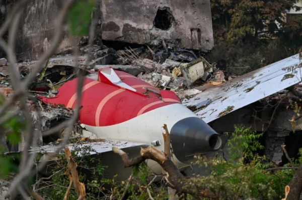 Debris representing the tail section of an Air India Boeing 787-8 is pictured in a residential area near the airport in Ahmedabad on June 14, 2025, after Flight 171 crashed shortly after takeoff on June 12. Investigators have recovered the black box containing the crash scene of the London-bound passenger jet that crashed into a residential area in the Indian city of Ahmedabad on June 13, killing at least 265 people on board and on the ground. (Photo: Puneet Paranjpe/AFP) (Photo: Puneet Paranjpe/AFP via Getty Images)