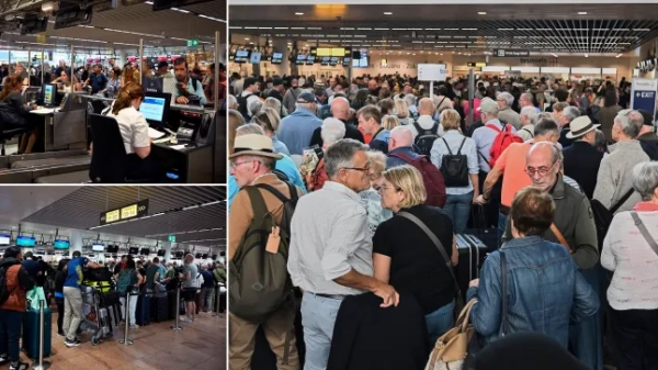 People queue to check in after a cyberattack caused delays at Brussels International Airport in Zaventem, Belgium, Saturday, Sept. 20, 2025. (AP Photo/Harry Nakos)