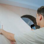 Pair remodeling vintage house shocked by find beneath wall covering