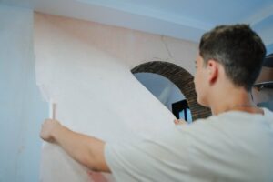 Pair remodeling vintage house shocked by find beneath wall covering