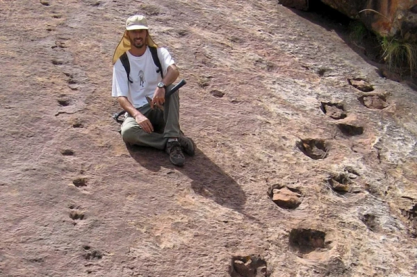 Argentinean paleontologist Pablo Gallina is shown in 2008 next to several dinosaur footprints discovered by two countrymen in the Icla municipality, Chuquisaca, Bolivia . Photo by Omar Medina Ramirez/EPA